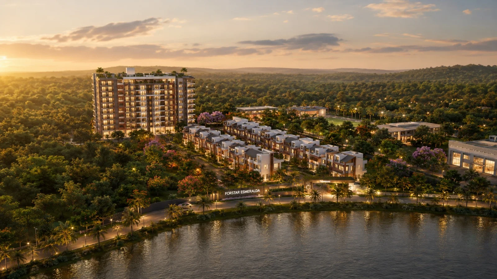 High-resolution aerial view of a luxurious waterfront residential development at twilight, featuring modern villas, a multi-storey apartment building, landscaped gardens, sports fields, illuminated roads, and a lakeside promenade surrounded by dense green